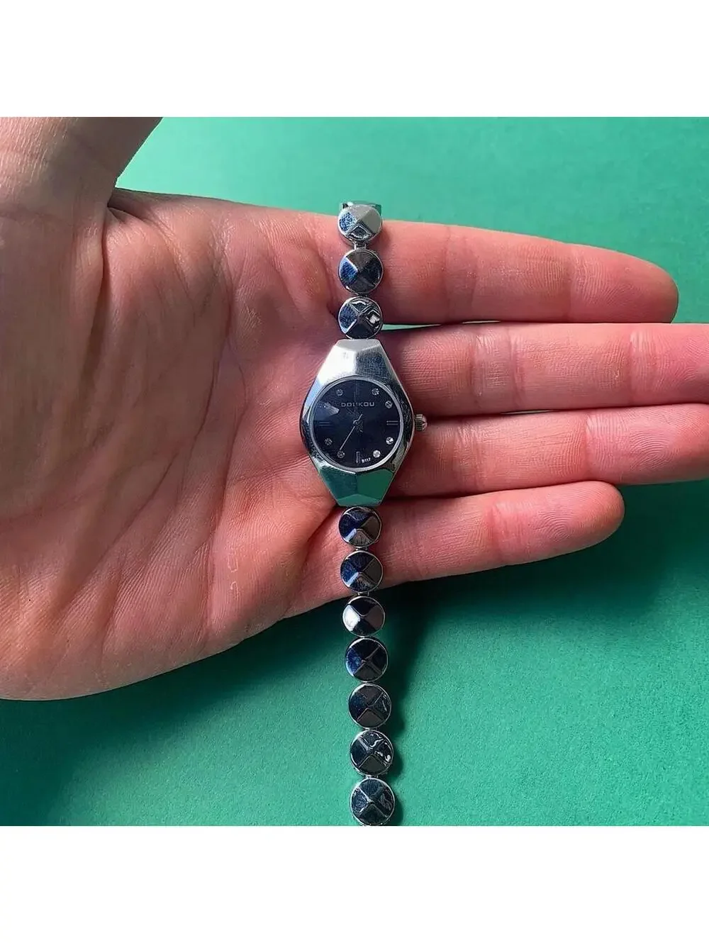 Black and silver watch with a unique design with rhinestones